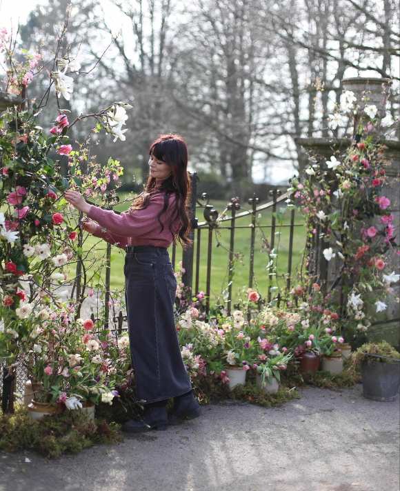Founder of May & June making the final adjustments to a wedding floral installation made using all locally grown seasonal British flowers